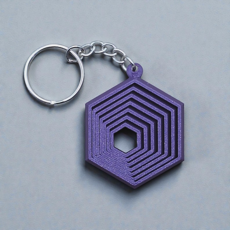 Handmade and customizable hex fidget keychains shown in indigo purple, featuring colorful designs, perfect for kids birthday parties, classroom prizes, sensory play, and party favor gifts.