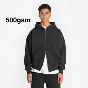 May include: A black zip-up hoodie with a 500gsm weight. The hoodie has a relaxed fit and a drawstring hood.