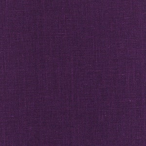 May include: A close-up of a deep purple fabric with a textured woven pattern.