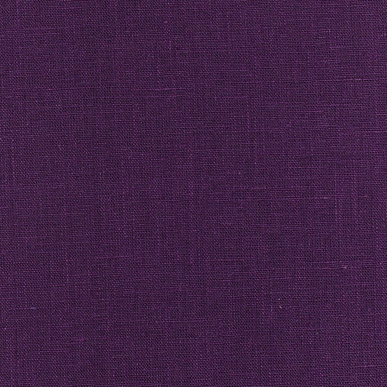 May include: A close-up of a deep purple fabric with a textured woven pattern.