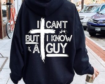 May include: Black hooded sweatshirt with a white cross and the text "I can't but I know a guy" printed on the back.