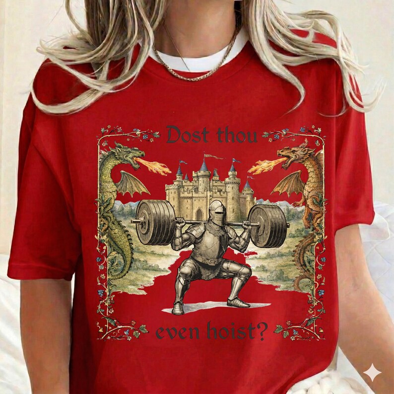 May include: Red t-shirt featuring a medieval knight lifting a barbell in a squat position. The design includes a castle, dragons, and the text "Dost thou even hoist?" in a decorative frame.