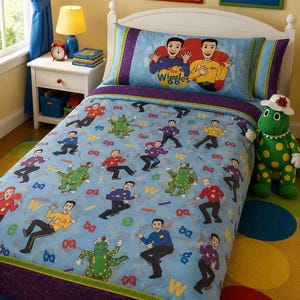 May include: A twin-sized bed set featuring The Wiggles characters on a light blue background with a purple border. The bedding includes a pillowcase and comforter decorated with illustrations of the musical group and a green dinosaur character.