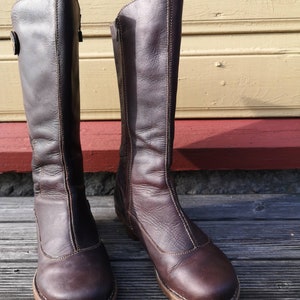 Front view of El Naturalista boots in dark brown leather with a clean, classic design, highlighting their rustic charm and durable craftsmanship.