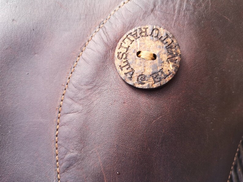 Close-up of the El Naturalista logo on a circular detail, emphasizing the brand’s eco-friendly ethos and handcrafted quality.