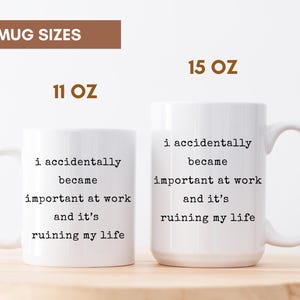 May include: Two white ceramic mugs with black text that reads "i accidentally became important at work and it's ruining my life." The mugs are labeled 11 oz and 15 oz. The mugs have a curved handle.