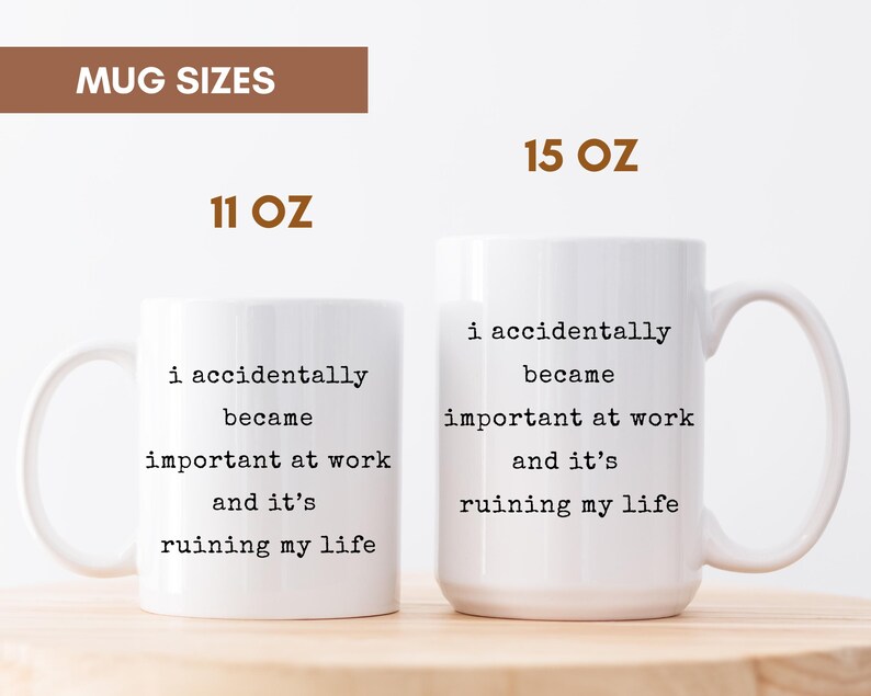 May include: Two white ceramic mugs with black text that reads "i accidentally became important at work and it's ruining my life." The mugs are labeled 11 oz and 15 oz. The mugs have a curved handle.