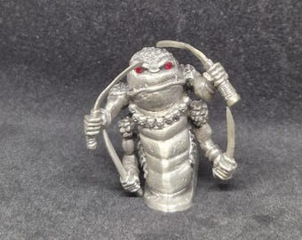 Figura vintage de peltre de Ral Partha: Hombres Serpiente del Caos, Enano Higgat, Rebanador