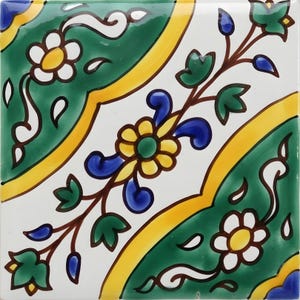 May include: Square ceramic tile with a floral design. The tile features a white background with a green, yellow, and blue floral pattern. The flowers are yellow with white petals, and the leaves are green.