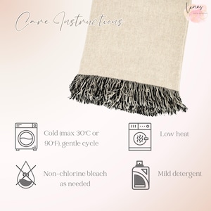 May include: A beige throw blanket with a black and white fringe. The image includes care instructions: cold wash (max 90&deg;F), gentle cycle, low heat, non-chlorine bleach as needed, and mild detergent.