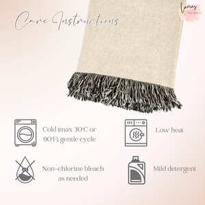 May include: A cream-coloured blanket with a black and white fringe. The blanket has the words "Care Instructions" in script. The care instructions include a washing machine icon, a low heat icon, a non-chlorine bleach icon, and a mild detergent icon.