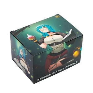 May include: A square deck box with a fantasy illustration of a woman with blue hair, glasses, and a potion. The box is labeled "IMPERIUM CHUBBY DECKBOX" in white text. The background is a dark green with glowing orbs.