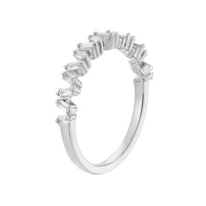 May include: A silver ring with a row of baguette-cut gemstones. The gemstones are set in a zig-zag pattern along the top of the ring. The ring is set against a white background.