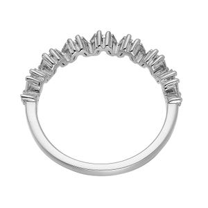 May include: A silver ring with a row of sparkling, rectangular-cut gemstones. The gemstones are set in a zig-zag pattern along the top of the ring. The band is smooth and polished, reflecting light.