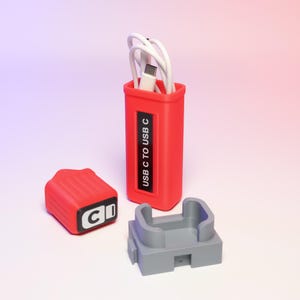 May include: A red USB C to USB C cable organizer with a white cable inside. The organizer has a matching red lid and a gray base. The text "USB C to USB C" is printed on the organizer.