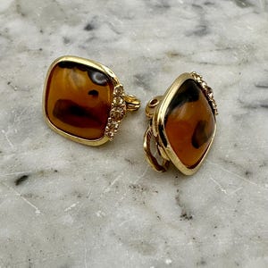 Vintage clip-on earrings cushion-cut cabochon dark amber or faux tortoise shell pattern gold-tone frame crystal accents - As Is - 0.75”w