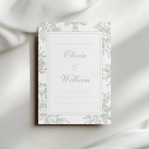 May include: A rectangular wedding invitation with a floral border in a soft green hue. The invitation features the names "Olivia & William" in elegant script. The text is centered on a white background.