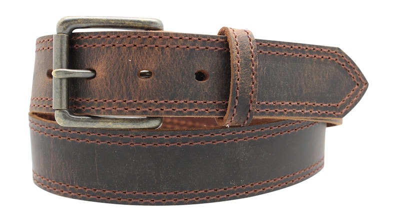 May include: A brown leather belt with a silver buckle and double stitching. The belt is distressed and has a worn look.