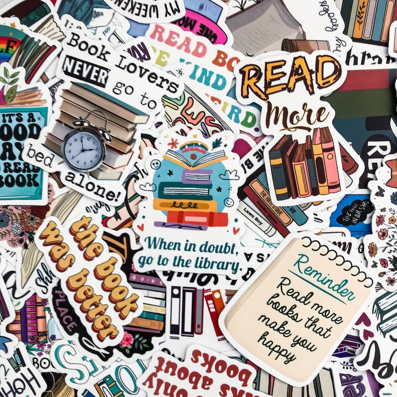 May include: A collection of colorful stickers with book-themed designs. The stickers feature phrases like "Read More," "Book Lovers," and "When in doubt, go to the library." Some stickers depict stacks of books, clocks, and open books.