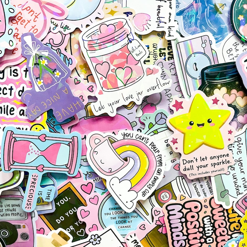May include: A collection of colorful stickers with various designs and text. Stickers include a jar filled with hearts, a yellow star with a smiling face, and phrases like "Let your love jar overflow" and "Don't let anyone dull your sparkle."