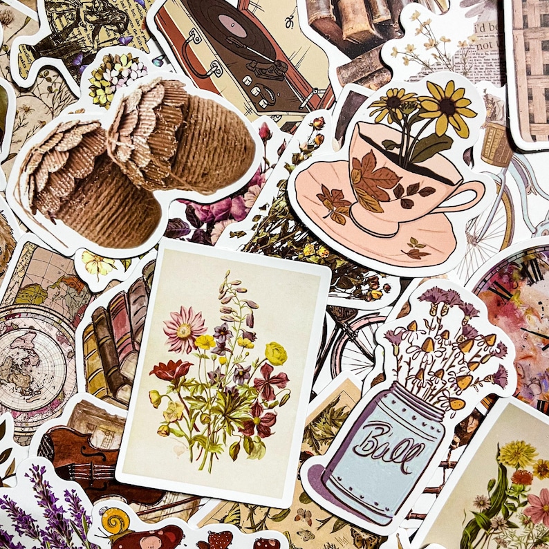 May include: A collection of vintage-style stickers featuring floral designs, a teacup with flowers, a record player, and a mason jar with flowers. The stickers are printed on white paper with a matte finish.