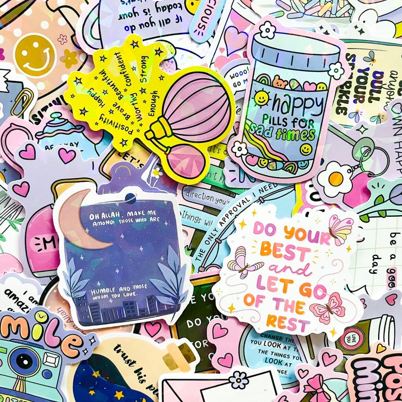 May include: A collection of colorful stickers with inspirational quotes and cute illustrations. Designs include a pill bottle with "happy pills for sad times", a perfume bottle, a moon with a quote, and butterflies. Perfect for decorating laptops, water bottles, or journals.