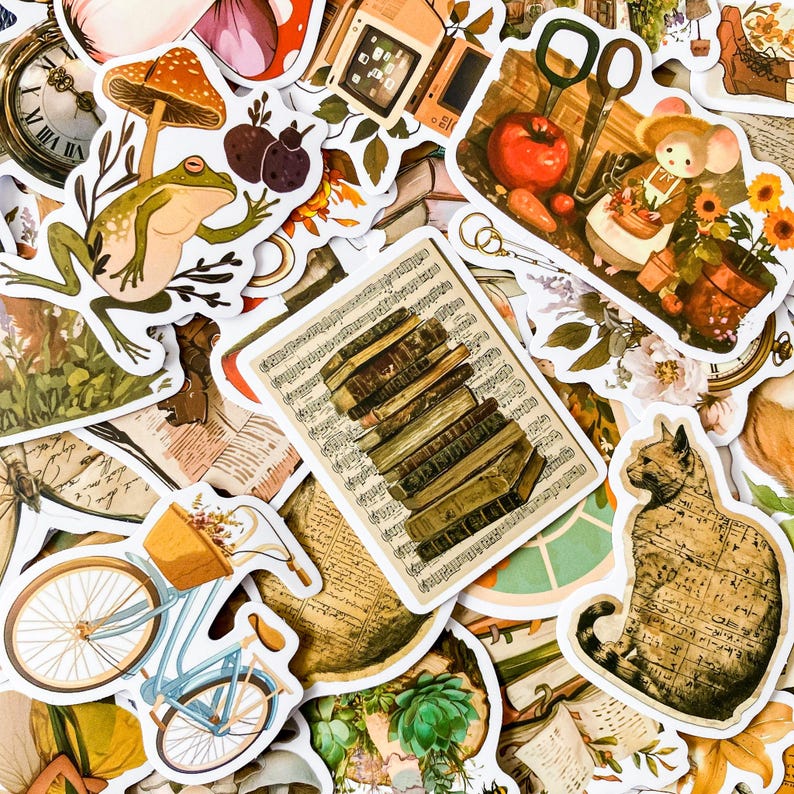 May include: A collection of vintage-style stickers featuring a variety of designs, including a frog, a cat, a stack of books, a bicycle, and a mushroom. The stickers are printed on white paper with a distressed, vintage look.