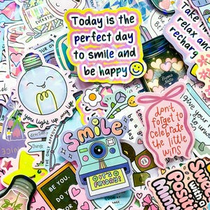 May include: A collection of colorful stickers with various designs and text. The stickers feature phrases like "Today is the perfect day to smile and be happy" and "It's Friday!" Other designs include a camera, lightbulb, and floral elements.