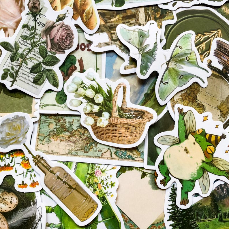 May include: A collection of vintage-style stickers featuring a variety of designs, including a basket of white flowers, a green frog with wings, a moth, and a map. The stickers are printed on white paper with a white border.