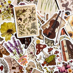 May include: A collection of vintage-style stickers featuring various botanical illustrations, a violin, mushrooms, and a suitcase. The stickers are printed on white paper with a distressed, aged look.