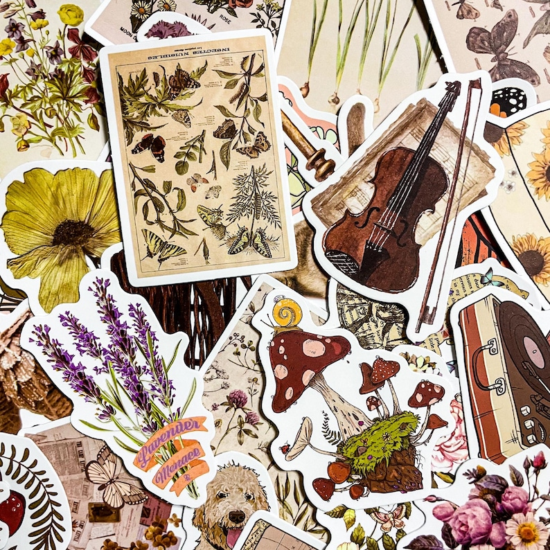 May include: A collection of vintage-style stickers featuring various botanical illustrations, a violin, mushrooms, and a suitcase. The stickers are printed on white paper with a distressed, aged look.