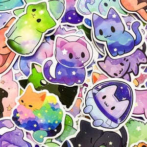 May include: A collection of colorful cat stickers with galaxy and space themes. The stickers feature cats in various poses, including sitting, sleeping, and wearing astronaut helmets. The stickers are perfect for adding a touch of whimsy to laptops, water bottles, and other surfaces.