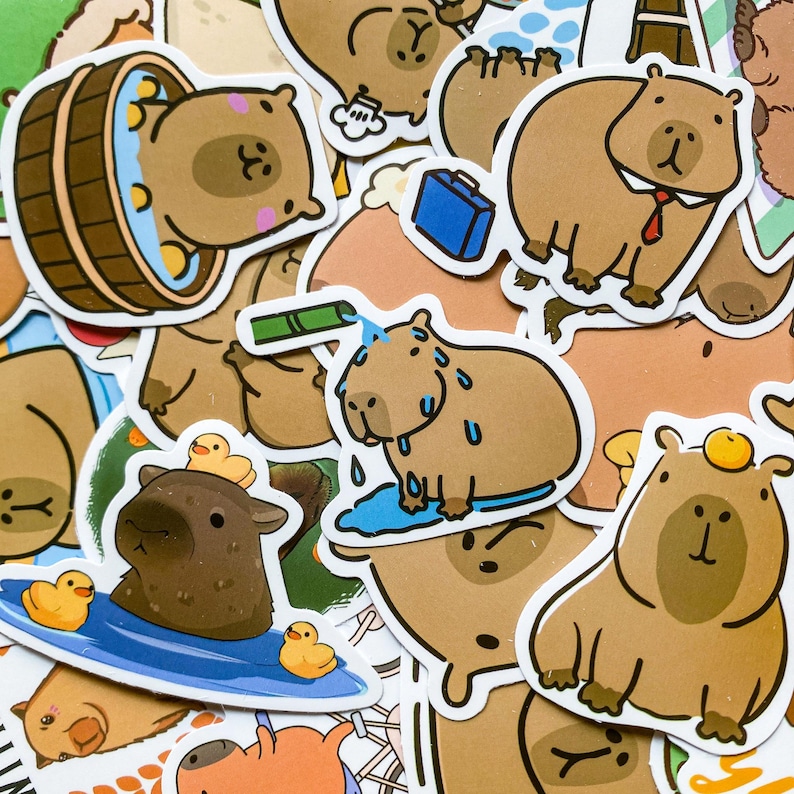 May include: A collection of various capybara stickers in different poses and settings. Some stickers show capybaras in a barrel, with rubber duckies, and wearing a tie. The stickers are brown and white with black outlines.