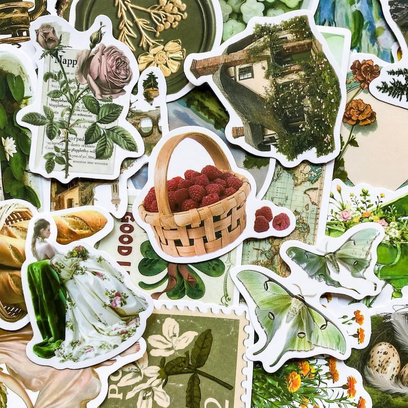 May include: A collection of vintage-style stickers featuring a variety of images, including a basket of red raspberries, a house in a tree, a woman in a white dress, a butterfly, and a floral design. The stickers are printed on white paper and have a distressed, vintage look.