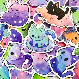 May include: A collection of colorful cat stickers with galaxy and star designs. The stickers feature cats in various poses, including sleeping on a cloud, swimming in a pool, and sitting on a plate. The stickers are perfect for adding a touch of whimsy to laptops, water bottles, and other surfaces.