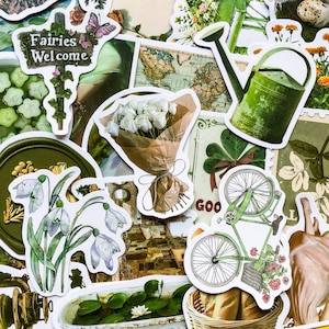 May include: A collection of green and white stickers featuring a bouquet of white flowers, a watering can, a bicycle, a sign that says "Fairies Welcome", and other nature-themed designs.