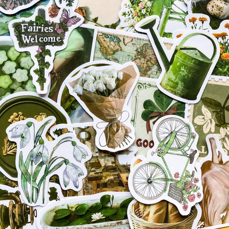 May include: A collection of green and white stickers featuring a bouquet of white flowers, a watering can, a bicycle, a sign that says "Fairies Welcome", and other nature-themed designs.