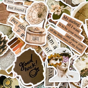 May include: A collection of vintage-style stickers featuring a gramophone, a quote about love, a bust of a man with flowers, and the words "good luck!" The stickers are printed on brown paper with white borders.