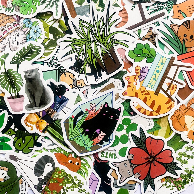 May include: A collection of colourful stickers featuring cats, plants, and geometric shapes. The stickers are printed on white paper and have a glossy finish.