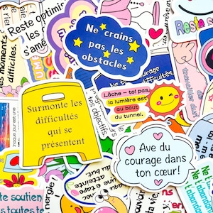 May include: A collection of colorful stickers with motivational phrases in French. The stickers feature various shapes, including clouds and a yellow caution sign. The phrases include "Ne crains pas les obstacles" and "Surmonte les difficultés qui se présentent."