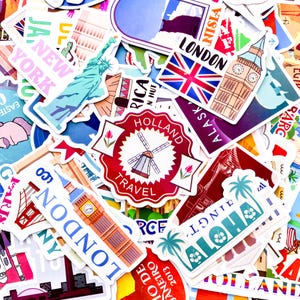 May include: A collection of colorful travel-themed stickers featuring iconic landmarks and destinations. Stickers include the Statue of Liberty, Big Ben, the London skyline, a windmill, and the word "ALOHA".