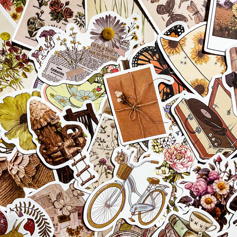 May include: A collection of vintage-style stickers featuring various designs, including a bicycle, a record player, a house, a floral pattern, a butterfly, and a wrapped package. The stickers are printed on white paper with a matte finish.
