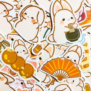 May include: A collection of cute bunny stickers with various designs, including a bunny holding a fan, a bunny holding a bowl of food, and a bunny holding a dango. The stickers are all white with brown outlines and have a whimsical, cartoonish style.