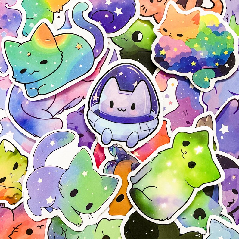 May include: A collection of colorful cat stickers with galaxy and space themes. The stickers feature cats in various poses, including a cat in a spaceship, a cat with a rainbow tail, and a cat with a green and purple galaxy design.