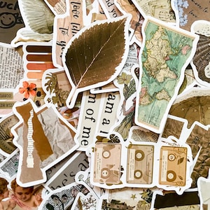 May include: A collection of vintage-style stickers featuring various designs, including a leaf, a world map, a cassette tape, and text phrases like "love like", "am a", and "dream of me". The stickers are printed on a white background with brown and beige accents.