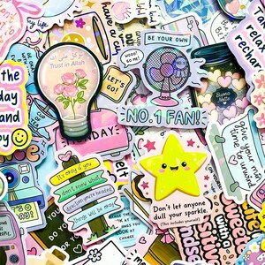 May include: A collection of colorful stickers with various designs and text. Stickers include a lightbulb with roses, a fan with "No. 1 Fan!", a yellow star, and phrases like "Be Your Own" and "Don't let anyone dull your sparkle."