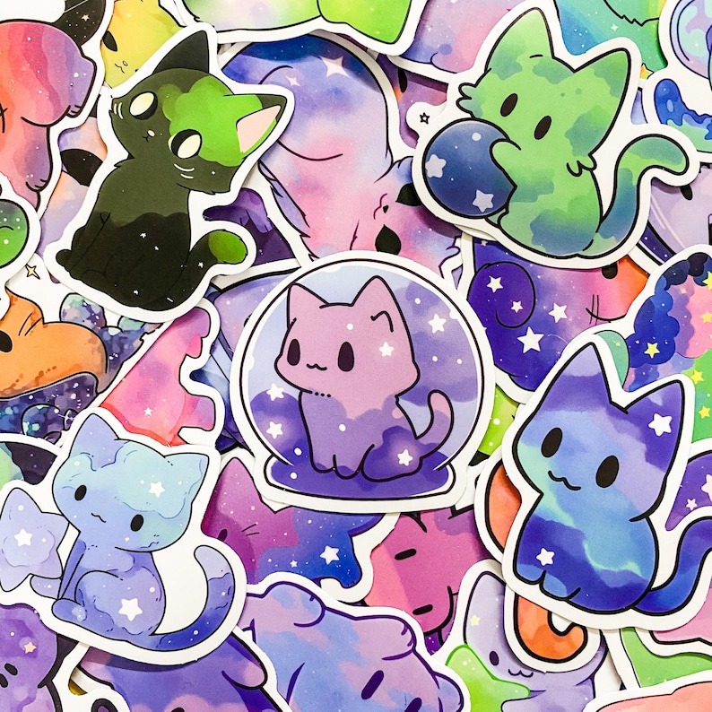May include: A collection of colorful cat stickers with galaxy and space themes. The stickers feature different cat poses and designs, including a cat in a snow globe, a cat with a galaxy tail, and a cat with a galaxy head. The stickers are perfect for adding a touch of whimsy to laptops, water bottles, journals, and more.