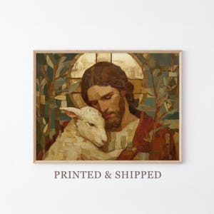 May include: A framed print of a religious painting. The artwork depicts a man with long brown hair and a beard, embracing a white lamb. The man is wearing a red robe. The background features a stained-glass window and foliage. The text "PRINTED & SHIPPED" is at the bottom.
