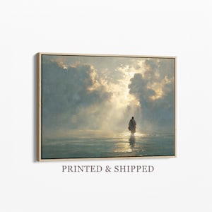 May include: A framed art print depicting a figure walking in water towards a bright light. The artwork features a muted color palette with a focus on light and shadow. The text "PRINTED & SHIPPED" is at the bottom of the frame.