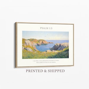 May include: Framed art print featuring a coastal landscape painting with a bay, cliffs, and blue water. The text "PSALM 1:3" is at the top, with a Bible verse below. The print is in a light wood frame.